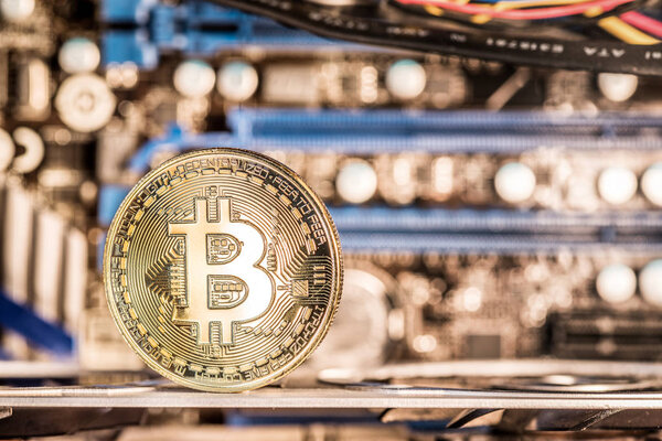 Shiny physical bitcoins and record-keeping equipment. Mining farm.