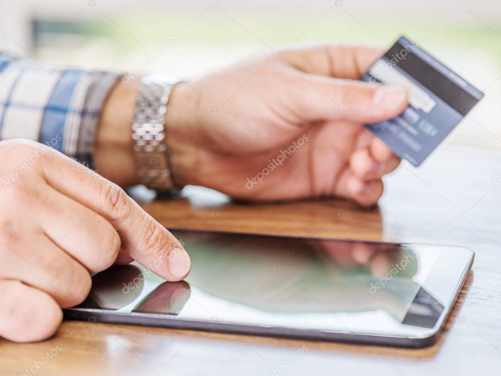 Online shopping using credit card and tablet computer.