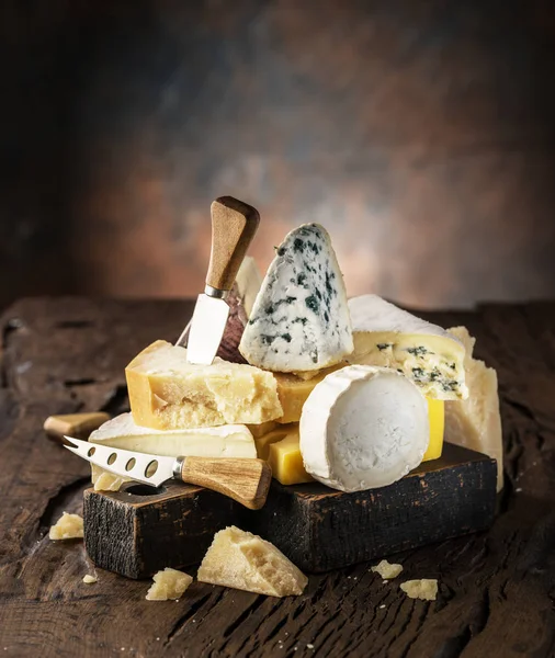 Assortment of different cheese types on wooden background. Chees — Stock Photo, Image