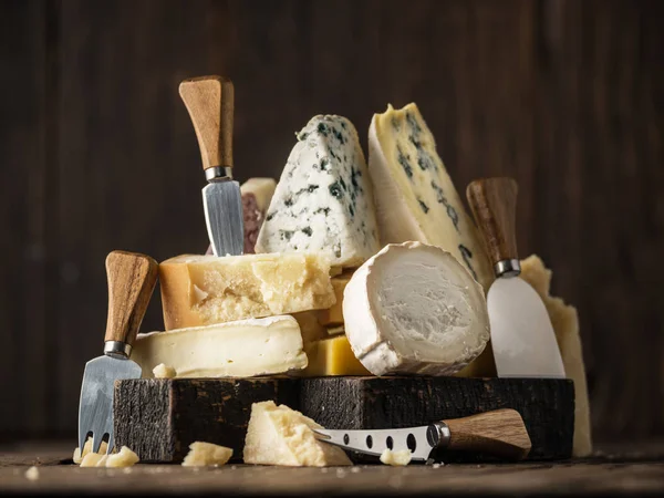 Assortment of different cheese types on wooden background. Chees — Stock Photo, Image