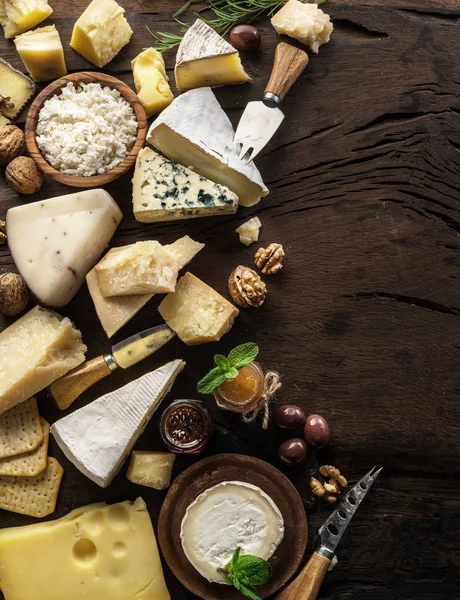 Assortment of different cheese types on wooden background. Top v — Stock Photo, Image