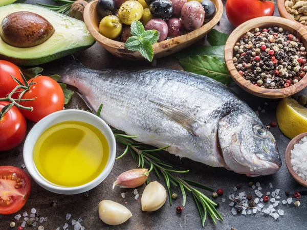 Raw dorado fish with spices and vegetables on the graphite board — Stock Image Raw dorado fish with spices and vegetables on the graphite board Stock Image