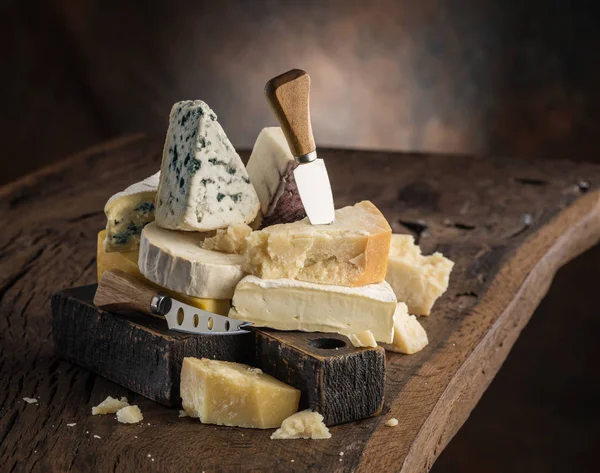 Assortment of different cheese types on wooden background. Chees — Stock Photo, Image