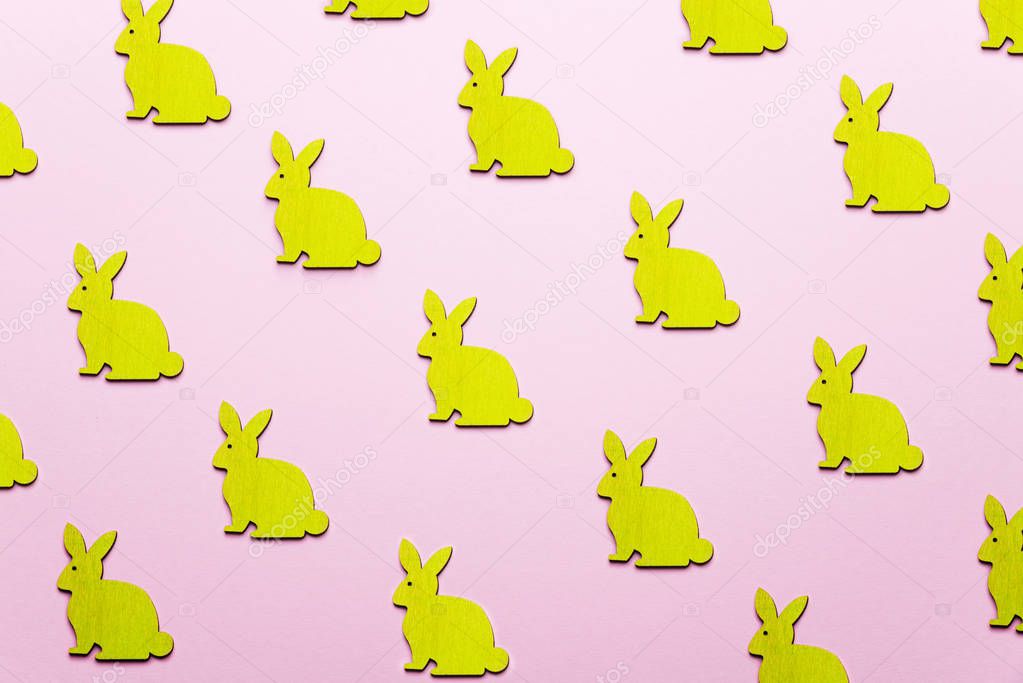 Wooden Easter Bunnies as attribute of Easter celebration. Pink b