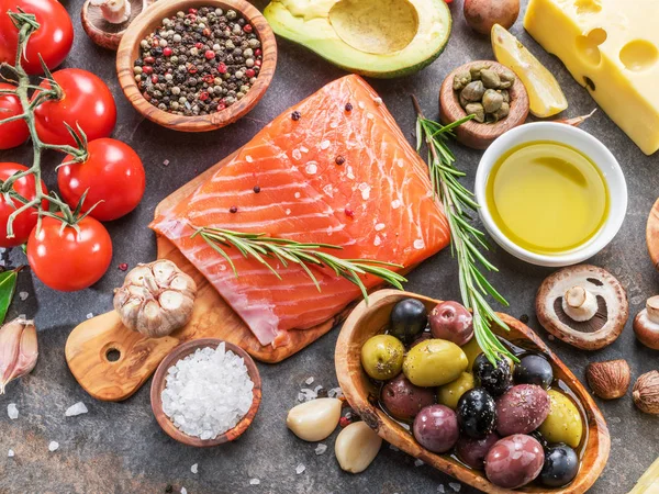 Salmón crudo con especias y verduras en el tablero de grafito . — Foto de Stock