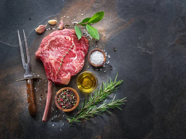 Raw  Rib eye steak or beef steak on the graphite board with herb