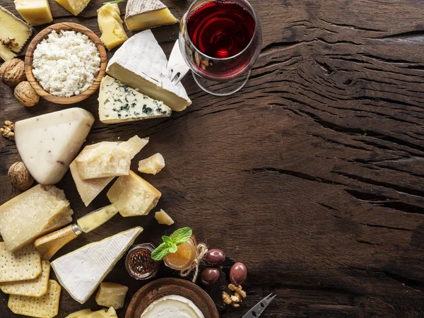 Prato de queijo com queijos orgânicos, frutas, nozes e vinho em wo — Fotografia de Stock