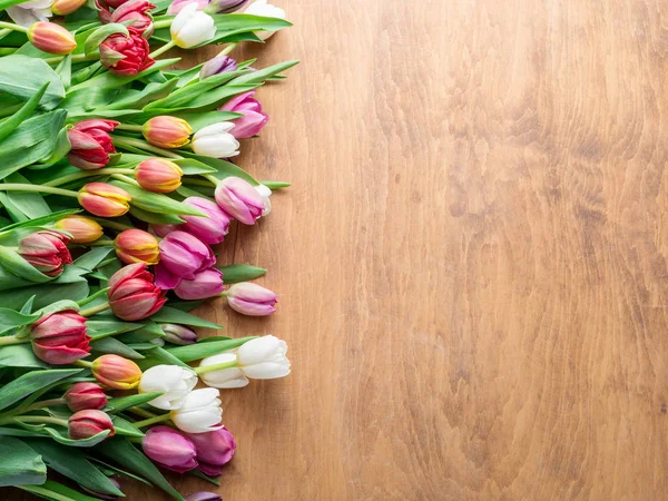 Kleurrijk boeket tulpen op houten achtergrond. — Stockfoto