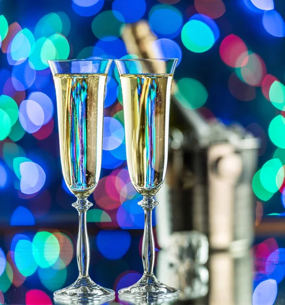 Bicchieri di champagne e bottiglia di champagne sul ghiaccio al bokeh ba — Foto Stock