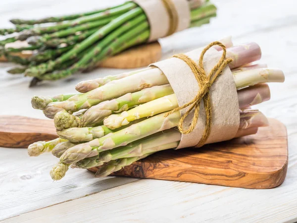 Paquetes de espárragos verdes y blancos sobre tabla de madera. Orgánica fo —  Fotos de Stock