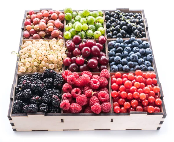 Colorful berries in wooden box on white background. Close-up. — Stock Photo, Image