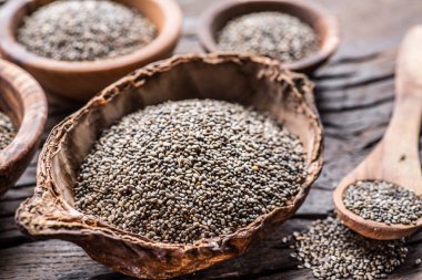 Eski ahşap masada farklı yemeklerle Chia tohumları. 