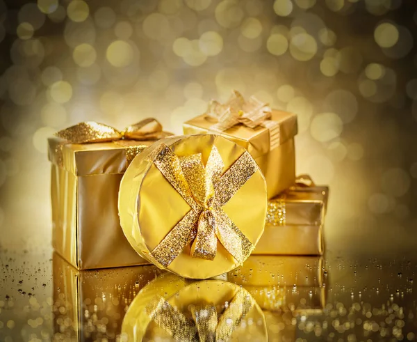 Golden gift boxes as a symbol of wishes and celebration. Golden — Stock Photo, Image