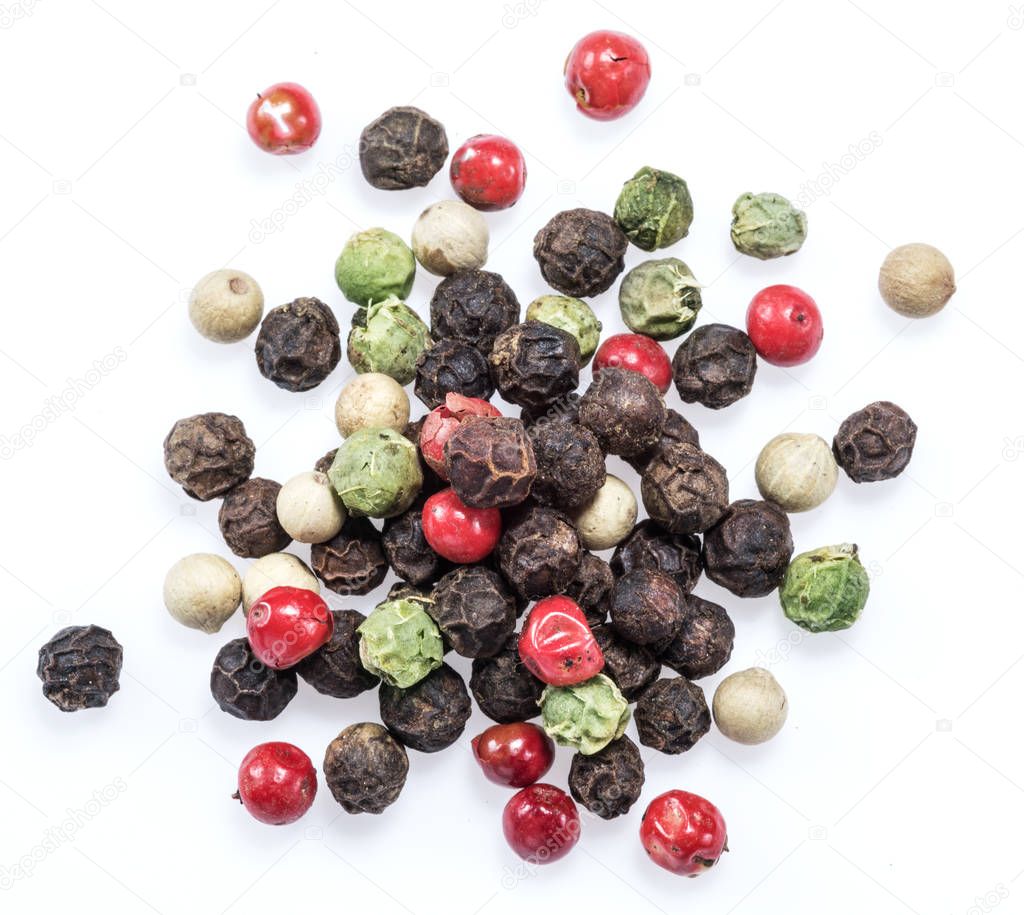 Black, white, green and red peppercorns isolated on white backgr