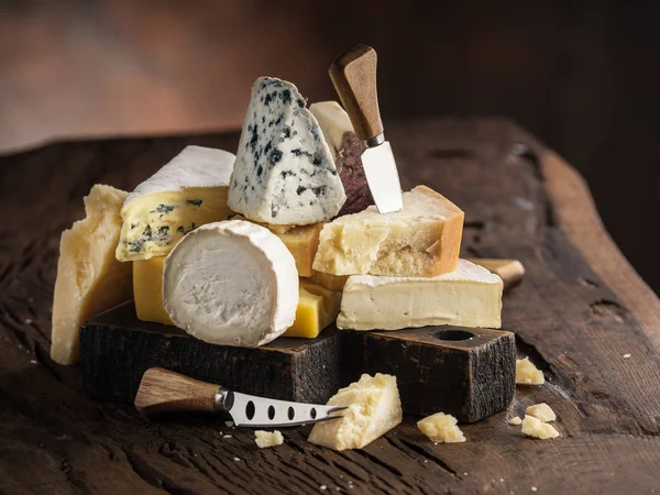 Assortment of different cheese types on wooden background. Chees — Stock Photo, Image