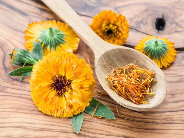 Calendula flowers on the old wooden table. — Stock Photo, Image