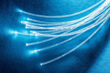 Uçları ışıklar ile optik liflerin paketi. Mavi artalan