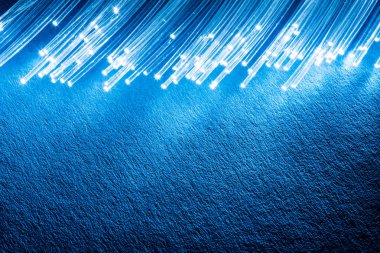 Bundle of optical fibers with lights in the ends. Blue backgroun clipart