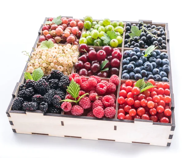 Colorful berries in wooden box on white background. Top view. — Stock Photo, Image