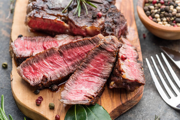Medium rare Ribeye steak with herbs and a piece of oil on the
