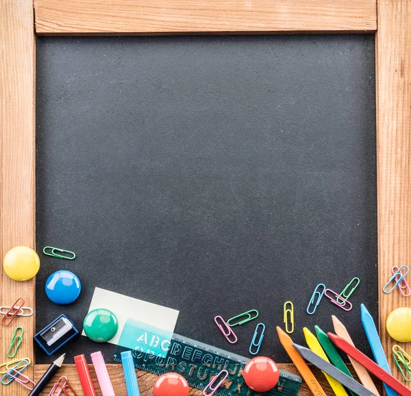 Blackboard and different school things. Close up. — Stock Photo, Image