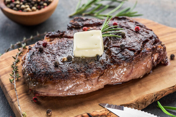 Medium rare Ribeye steak with herbs and a piece of oil on the
