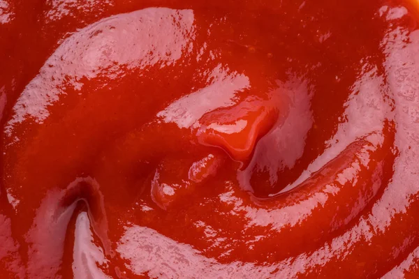 Red tasty tomato ketchup puddle close-up. — Stock Photo, Image