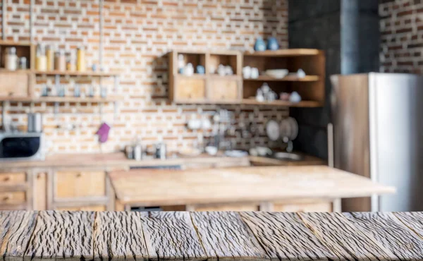 Old wooden table top and blurred kitchen interior at the backgro — Stock Photo, Image