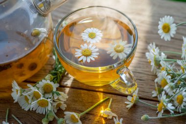 Tahta masada papatya çayı ve papatya çiçeği. Üst görünüm.