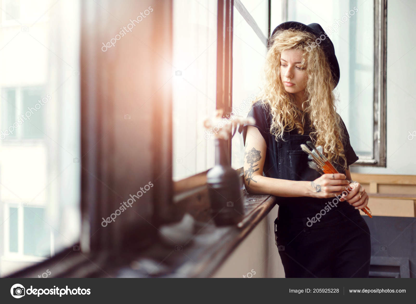 Curly Blonde Tattoed Artist With Brushes Stock Photo