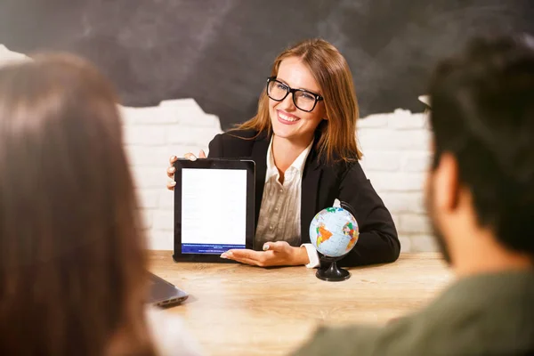 Travel Agent Giving Her Clients Tickets And Documents