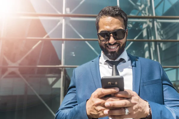 Bearded Businessman Use Phone Before Modern Building