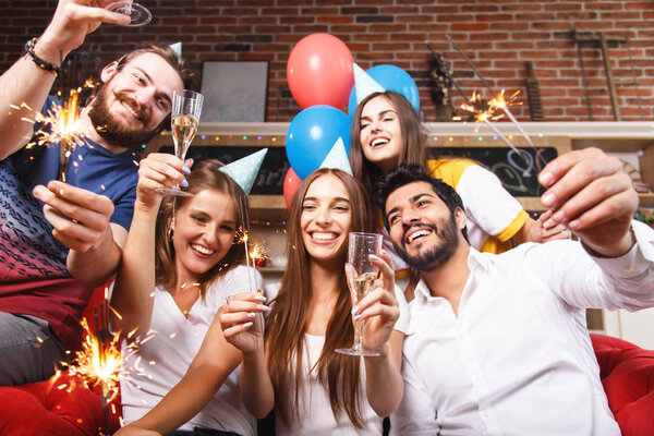 People Raising Glasses On The Sofa