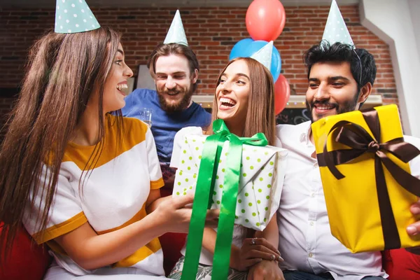 Group Of Friends Offering Gifts To Their Girlfriend