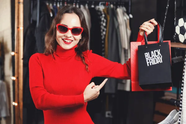 Successful Girl Showing Black Friday Bag