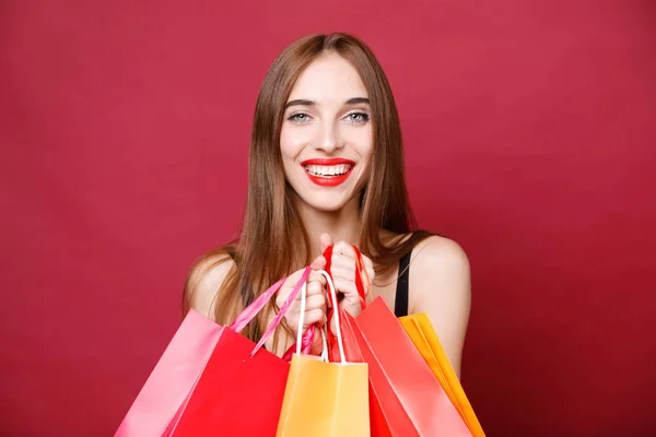 Mujer sexy sosteniendo muchas bolsas de compras —  Fotos de Stock