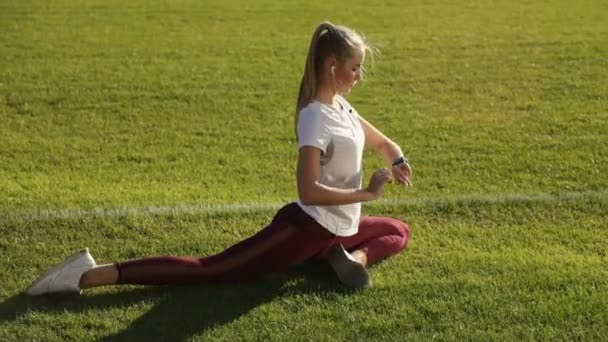 Girl Checks Message as Stretching — Stock Video