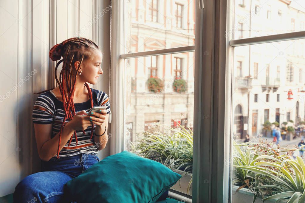 Hipster Girl With Dreads Using Smartphone