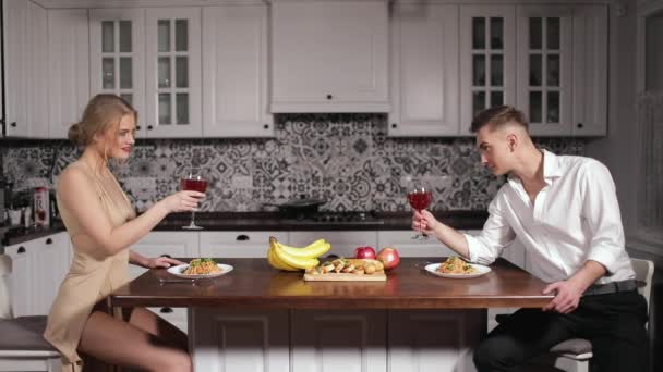 在厨房里吃浪漫晚餐的年轻夫妇 — 图库视频影像
