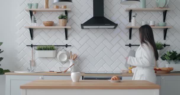 Chica alegre teniendo jugo y diversión en la cocina — Vídeos de Stock