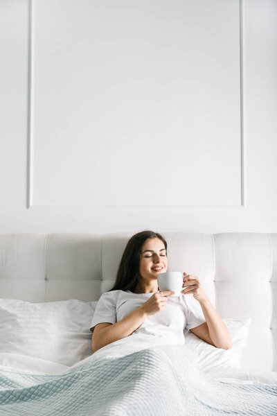 Woman Having Coffee at the Bed