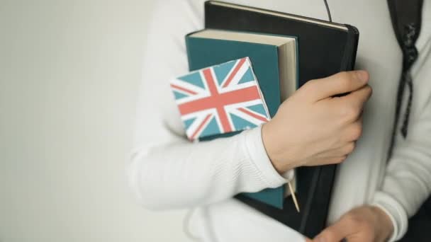 Person mit Büchern und Flagge von Großbritannien — Stockvideo