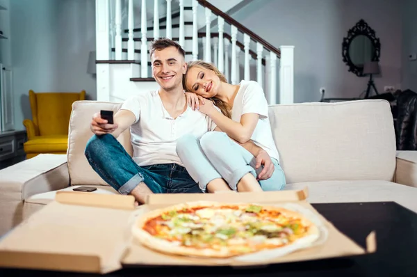 Couple Eating Pizza at the Sofa