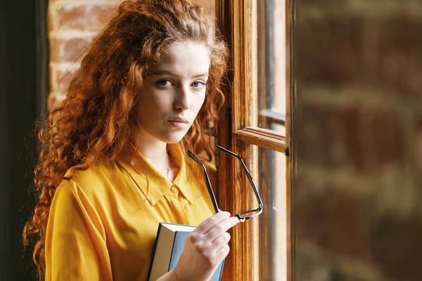 Ginger Girl Holding boek en glazen — Stockfoto