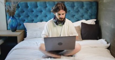 Freelancer oturma üzerinde yatak ile Laptop