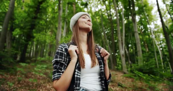 Femme avec sac à dos sentant l'air frais dans la forêt — Video