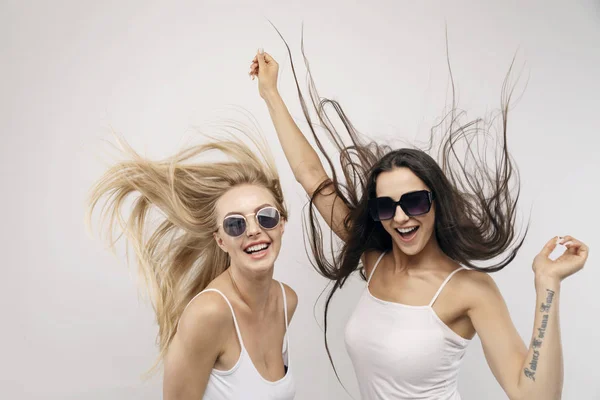 Two Girls Jumping Hair Fluttering Royalty Free Stock Images
