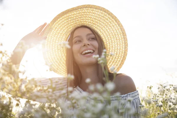 Cappello donna regolazione tra i fiori di campo — Foto Stock