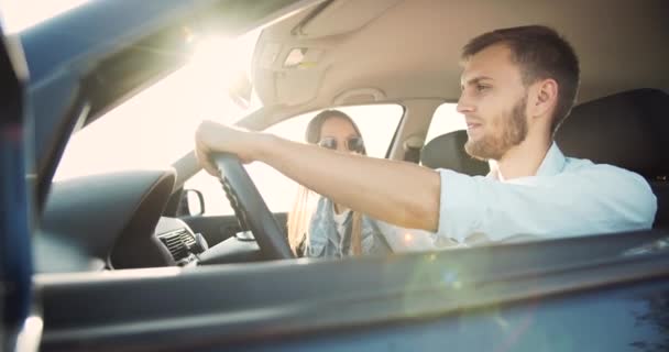 Pareja de conducción de coches en la puesta del sol — Vídeo de stock