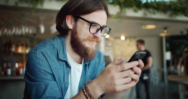 Мужской просмотр смартфона в кафе — стоковое видео